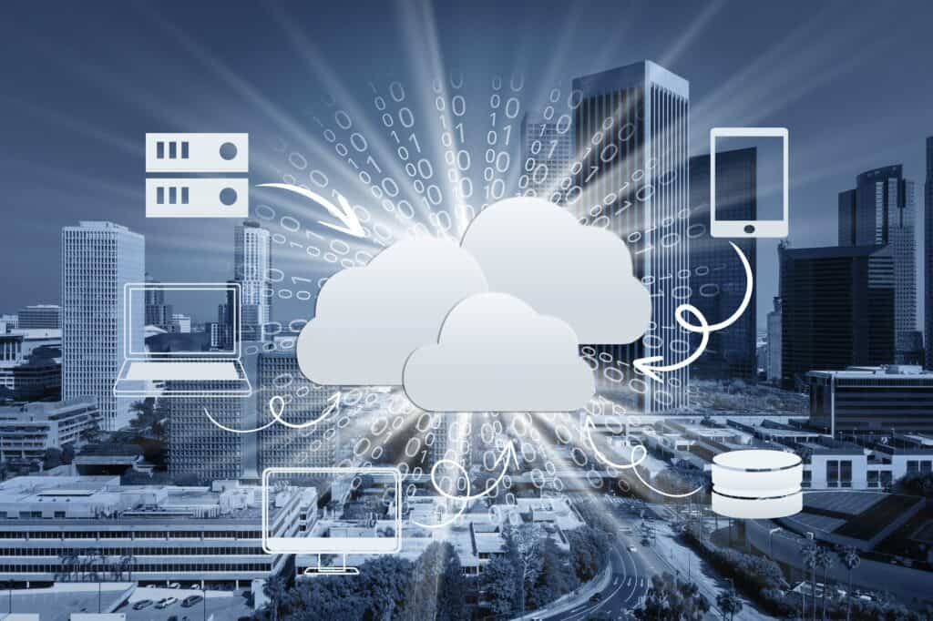 Illustration of cloud computing with data flow icons connecting laptops, servers, and mobile devices, set against a cityscape background.